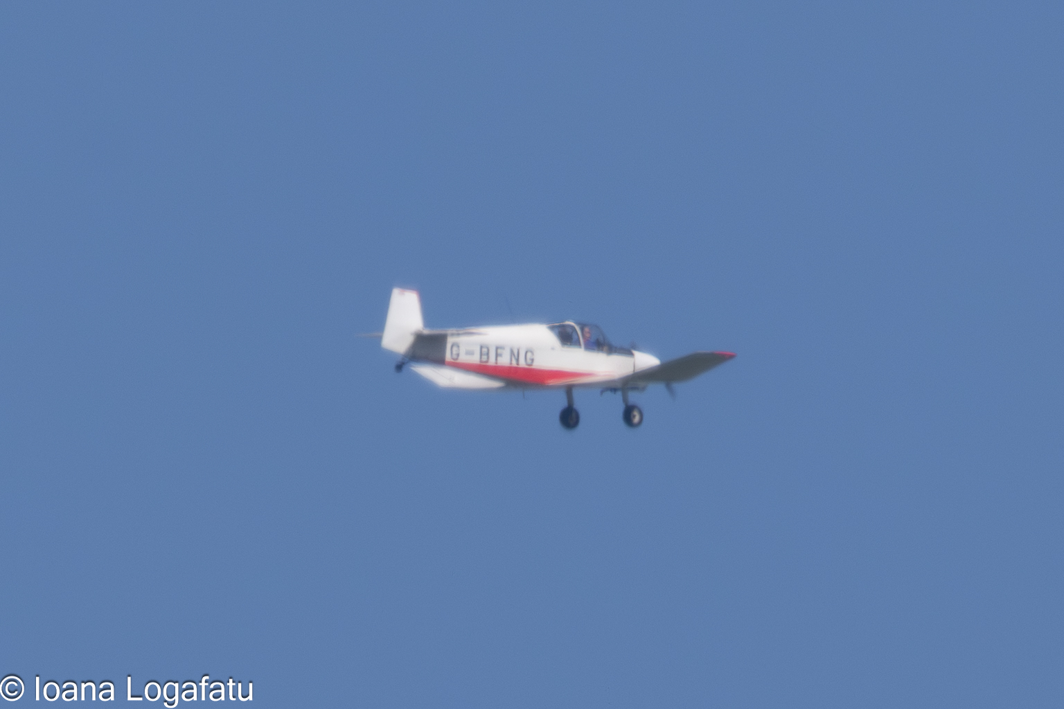 Vintage aircraft soaring through clear blue skies